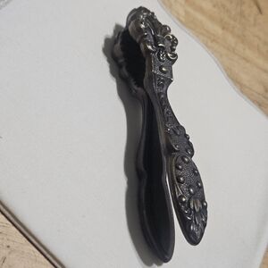 Vintage Metal Nutcracker featuring Ornate Floral-patterned Handles